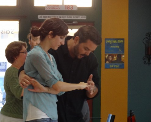 Man teaching girl how to dance