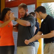 Dance teacher adjusting students