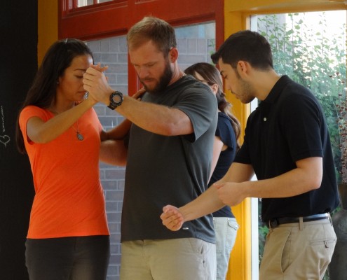 Dance teacher adjusting students