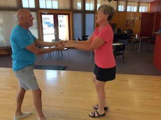 An older couple dancing together