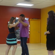 A man in a purple shirt dancing with people